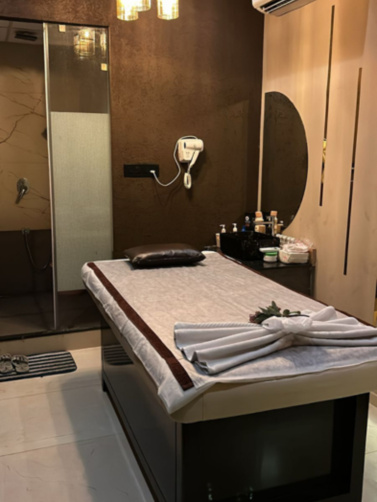 Modern spa room at Ella Spa with soft lighting and comfortable massage tables