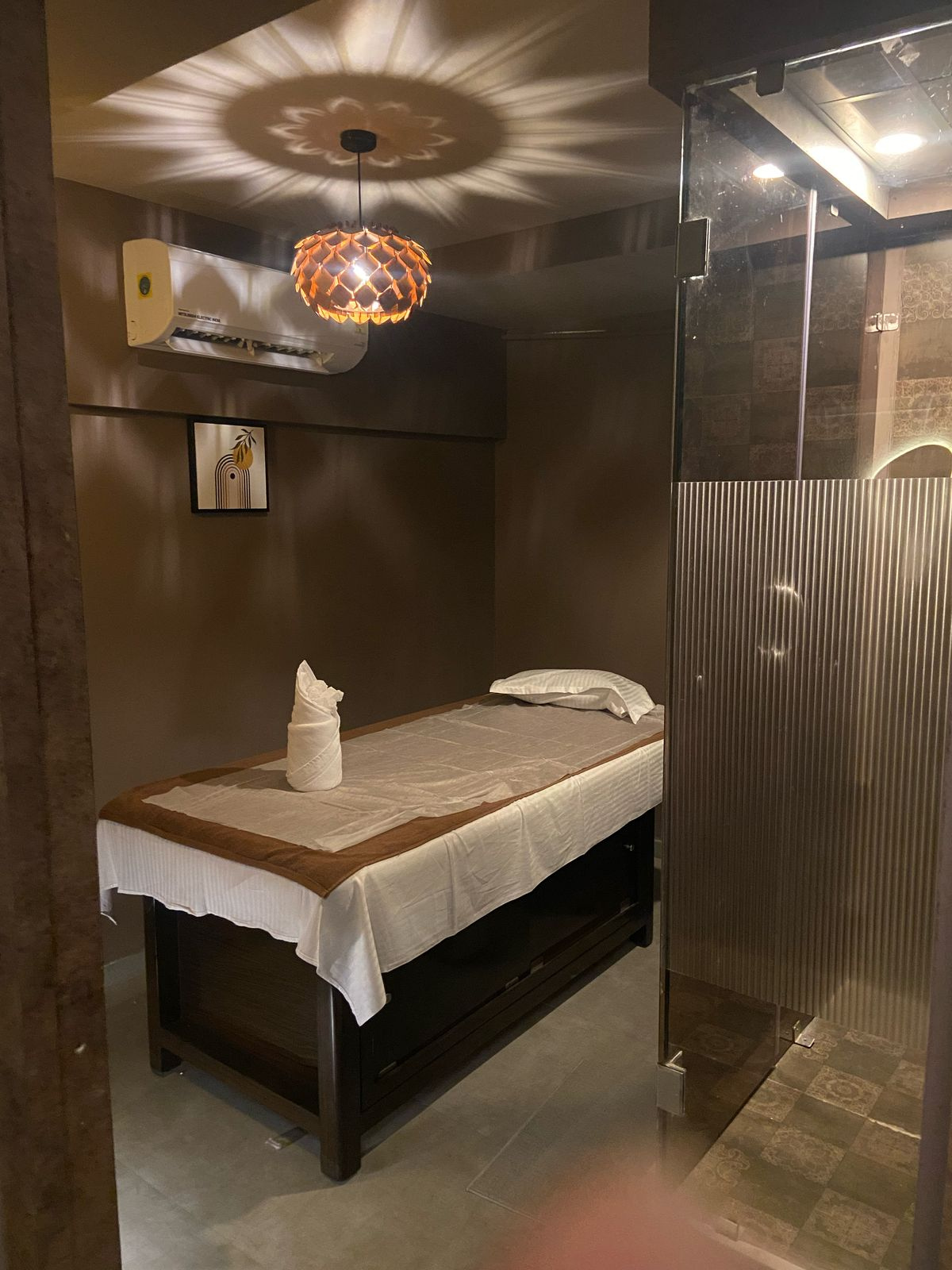 Modern spa room at Ella Spa with soft lighting and comfortable massage tables