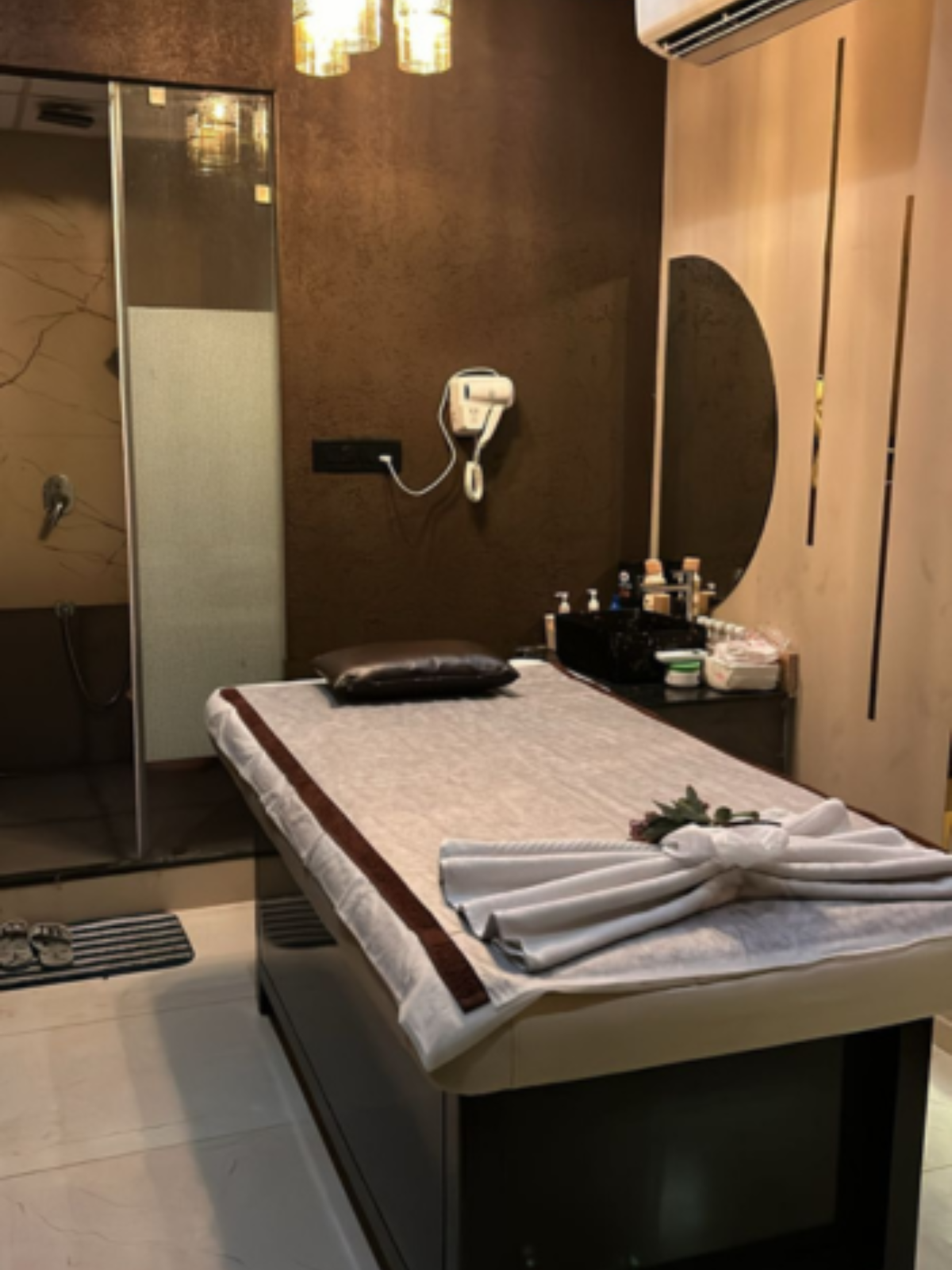 Modern spa room at Ella Spa with soft lighting and comfortable massage tables